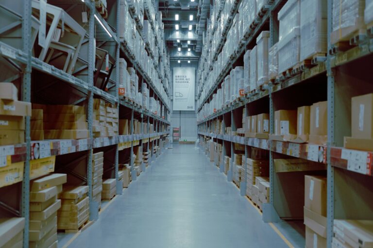 Long warehouse aisle with organised shelves of stock