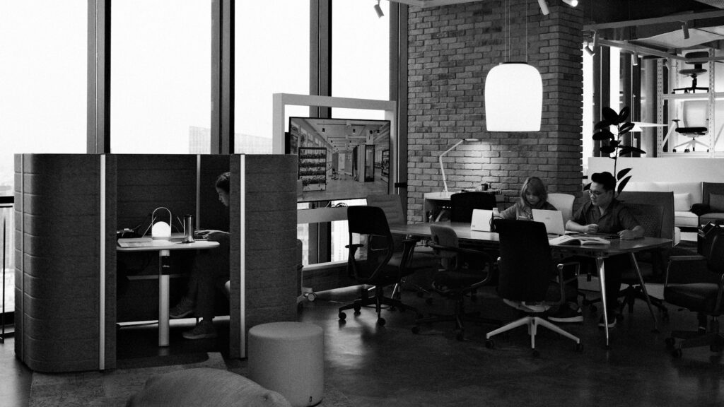Colleagues working at desks in a modern open-plan office