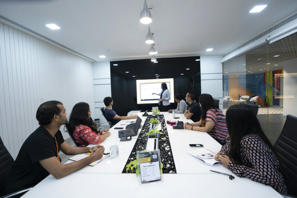 Colleagues listening to a presenter during a workshop in a Delhi NCR office