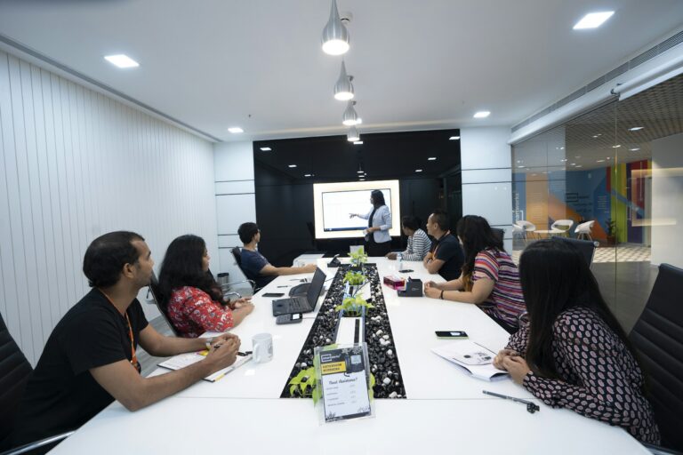 Colleagues listening to a presenter during a workshop in a Delhi NCR office